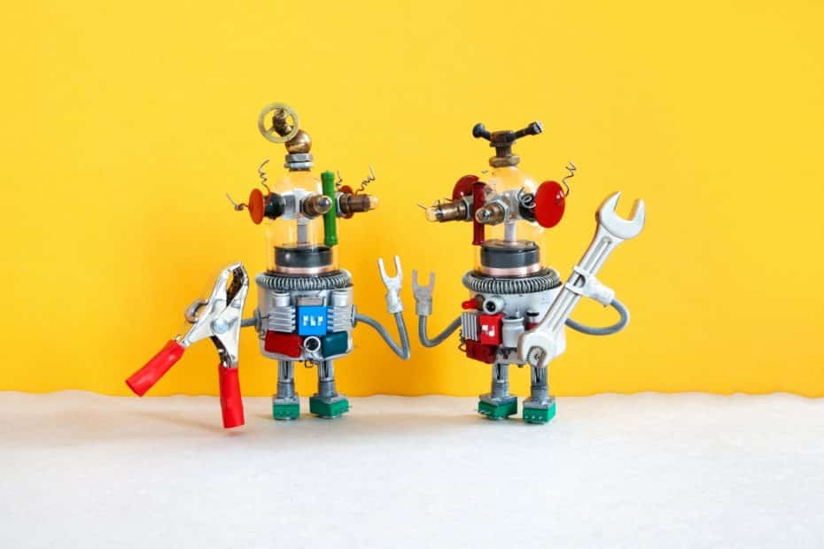 Two comical electrician robots are ready for maintenance.