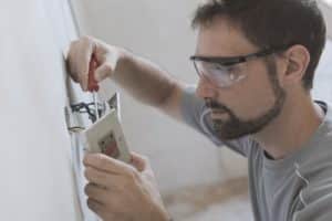 Professional electrician, installing sockets at home