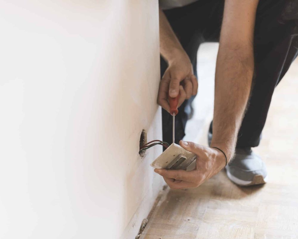 Professional electrician, installing sockets at home